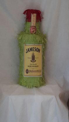 a bottle of jameson sitting on top of a white sheet