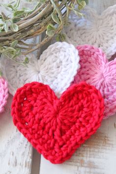 three crocheted hearts sitting next to each other