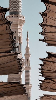 a tall white building with a clock on it's side and an awning over it