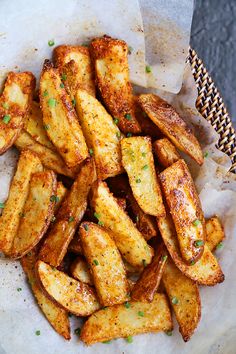 a basket filled with fried potatoes on top of a table