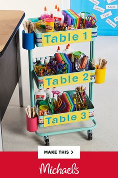 a cart with lots of school supplies on it and the words table 2, table 3 make this = michael's