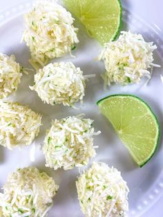 limes and rice balls on a plate with lime wedges next to them for garnish