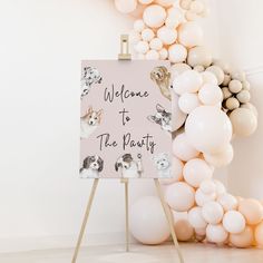 a welcome to the party sign surrounded by balloons