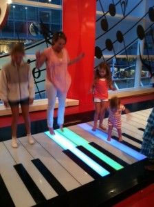 children are playing on an interactive piano