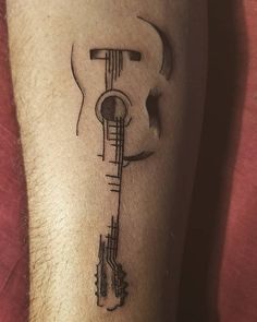 a man with a tattoo on his leg that has a musical instrument drawn on it