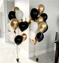 black, white and gold balloons in the shape of hearts