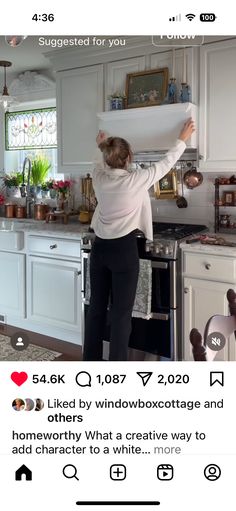 a woman standing in front of a stove top oven