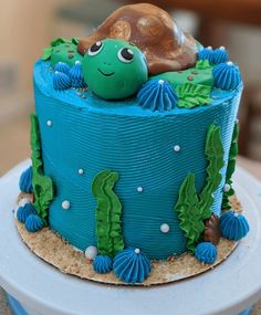 a blue cake with a turtle on top