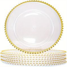 three plates stacked on top of each other with gold rims and beading around the edges