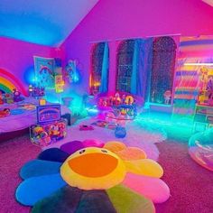 a room with lots of toys and decorations on the floor in front of a rainbow colored wall