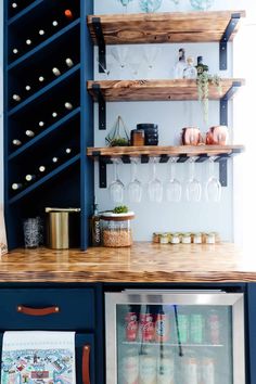 a kitchen with blue cabinets and shelves filled with wine glasses