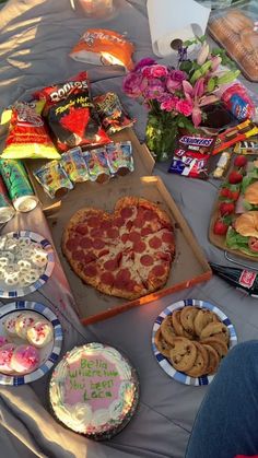 a table topped with lots of food and snacks