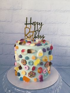 a birthday cake with colorful frosting and sprinkles