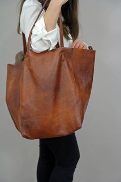 "Full Grain Leather bag, Big leather oversized bag, Cognac Brown large bag. Dimension details: Max width at the top: 60 cm / 23.6\" Height: 40 cm / 15.7\" Width at the base: 32 cm / 12.6\" Depth: 24 cm / 9.4\" Handle drop: 26 cm / 10\" Internal cosmetic bag: 30x20 cm / 12x8\" OTHER COLORS: CAMEL: https://www.etsy.com/listing/685507502/large-leather-tote-bag-large-bag-24x-16?ref=shop_home_active_2 GREEN: https://www.etsy.com/listing/682412608/extra-large-green-leather-tote-bag-24x?ref=shop_home_a Slouchy Tote, Leather Cosmetic Bag, Large Leather Bag, Everyday Handbag, Large Leather Tote Bag, Soft Leather Bag, Oversized Tote Bag, Oversized Bag, Oversized Tote