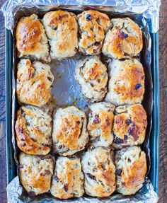 freshly baked hot cross buns in a baking tin