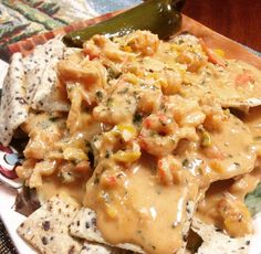 a white plate topped with nachos and cheese