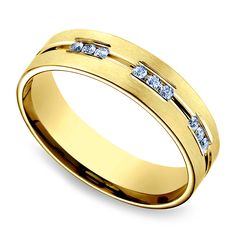 a yellow gold wedding ring with three diamonds