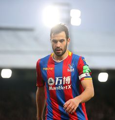 a man in a blue and red shirt on a soccer field