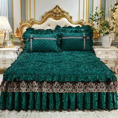 a bed with green bedspread and matching pillows