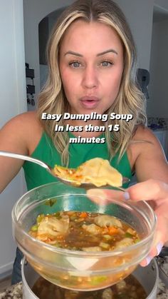 a woman holding a spoon over a bowl of soup with the text easy dumpling soup in less then 15 minutes