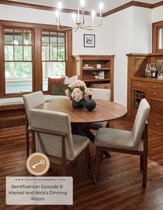 a dinning room table with chairs and flowers on it