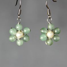 This delicate daisy earrings are handmade using jade and pearl. It is a perfect earring for everyday wear and gifts for your loved one. The size of the earrings is 1/2 inches, 12mm. ;-) My contact number: 626-379-1904. Please contact me if you would like to order multiples or customize a design for your special event, I will be pleased to give you a discount on a quantity order. ;-) Purchases will be shipped within 1-3 business days. In case of occasional shortage of beads material, purchases wi Handmade Flower Pearl Earrings, Handmade Flower-shaped Pearl Earrings, Handmade Pearl Dangle Flower Earrings, Handmade Pearl Flower Earrings Gift, Handmade Pearl Flower Earrings For Gift, Handmade Green Pearl Earrings For Gift, Green Dainty Flower Drop Earrings, Dainty Green Flower Earrings With Ear Wire, Elegant Flower Shaped Jade Jewelry