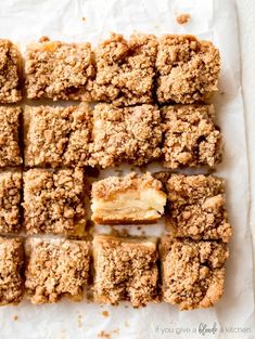 apple crumb bars cut into squares on top of parchment paper