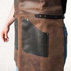 If you're a wood carver, artist, electrician, mechanic, butcher, chef, barber, or barista and value comfort and style in your workwear, then this AP3X Adjustable Leather Work Apron will not go unnoticed. This heavy-duty leather work apron model is designed to be the perfect gear to protect against dirt and injury and to become an important addition to your work look. This stylish work apron you see in front of you is crafted from high-quality brown and black leather that looks better and better Butcher Apron, All Instruments, Tool Apron, Work Apron, Work Accessories, Work Aprons, Leather Apron, Wood Carver, Big Pockets