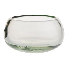 an empty glass bowl sitting on top of a table