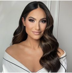 a woman with long dark hair and brown eyeshadow, posing for the camera