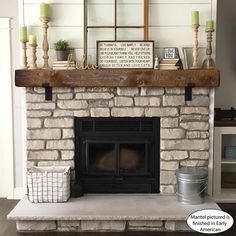 a fireplace is decorated with candles and other items on top of the mantels