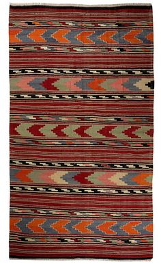 an old navajo rug with red, orange and grey colors