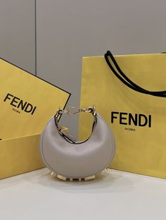 Description FND FNDgraphy Beige Mini Shoulder Bag For Woman 16.5cm/6.5in Rep 1:1 Size: 16.5 x 14 x 5 cm / 6.5 x 5.5 x 1.5 inch Mini hobo bag made of soft beige leather, decorated with vintage gold metal FND lettering visible when wearing the bag under the arm. Zipper closure with fabric-lined internal compartment, gold-finish metalware. Can be worn under the arm or cross-body thanks to the adjustable, detachable handle and the hooks that allow a shoulder strap to be attached. Beige Mini Includes box, dust bag. This product is of the best quality. Fendi Mini Bag, Mini Hobo Bag, Dream Bags, Leather Decor, Soft Beige, Mini Shoulder Bag, Evening Clutch Bag, Wallet Accessories, Fendi Bags