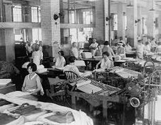 an old black and white photo of people working in a factory