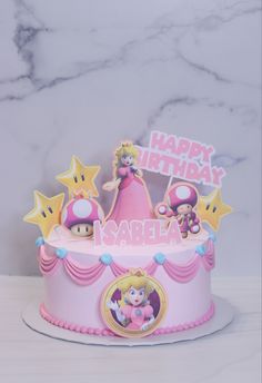 a pink birthday cake with mario and princess peaches on top, surrounded by stars