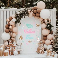 an outdoor christmas party with balloons, presents and decorations on the ground in front of a backdrop that says oh what fun