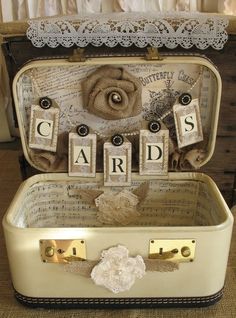 an old suitcase is decorated with letters and flowers