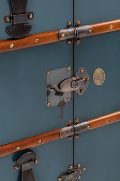 two pieces of blue luggage with brass hardware on the handles and handlebars are shown