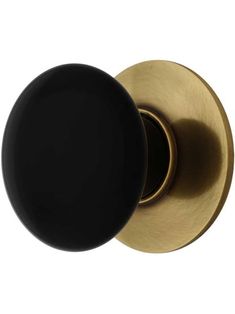 black and brass door knob with an oval handle