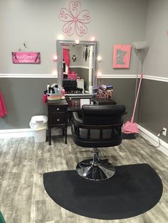 a salon with gray walls and pink accents