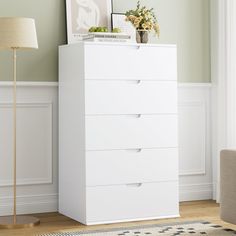 a white chest of drawers in a living room