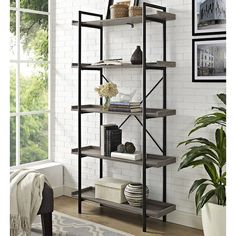 a room with a white brick wall and black metal shelving unit in the corner