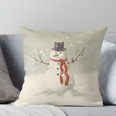 a snowman wearing a top hat and scarf throw pillow