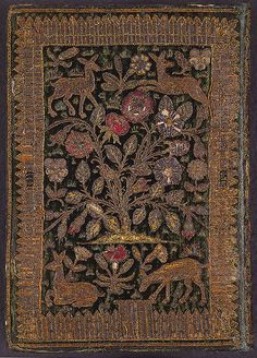 an embroidered cloth with animals and flowers on it