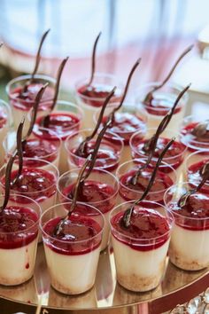 desserts are arranged on a tray with chocolate sticks sticking out of them