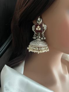 Bollywood Big Jhumka Earrings studded with carved stone, kundan, ghughroo bells and cluster pearls.  Very well made Jhumkis. Style this Jhumka Earrings with any Ethnic Attire and gather lot compliments. Navratri earrings. silver jhumkas. long silver Jhumka earrings.  💕This earring is sure a head turner & a conversation starter.  ✅Shop our collection here: https://www.etsy.com/shop/KKsCulture  WHAT GOES IN  👉🏻Brass base earrings 92.5 silver coating, Kundan, Cluster Pearls, Ghunghroo with carved stone.  👉🏻Push Back Closure.  CARE TIP  1. Keep away from moisture and perfume 2. Store in cotton or zip lock bags or air tight boxes. 3. Spot cleaning only. 4. Jewellery is the last thing you should wear and the first thing you should remove. 👉🏻Send us an email if you need help! KKsCulture [a Oxidized Silver Earrings Jhumka, Navratri Earrings, Big Jhumka Earrings, Oxidized Jhumkas, Silver Jhumka Earrings, Vintage Indian Jewelry, Silver Jhumkas, Pretty Jewelry Necklaces, Fancy Jewellery Designs