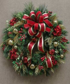 a christmas wreath with red and gold decorations