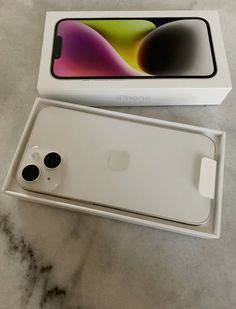 an iphone is sitting in its box on the table next to it's packaging