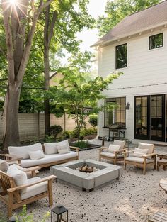 an outdoor patio with furniture and trees in the background