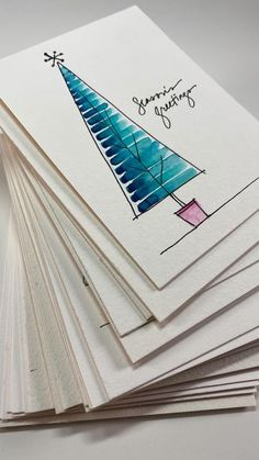 a stack of cards with a drawing of a christmas tree on top of each card